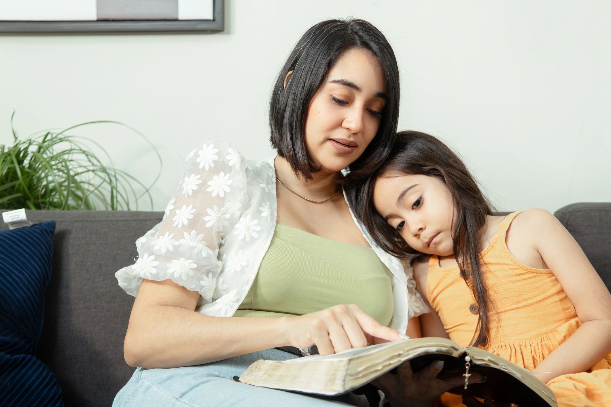 Parent and child reading together at home